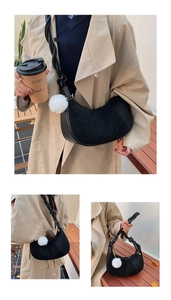 Detail of black crescent hobo bag featuring woven rope strap and suede patchwork textures
