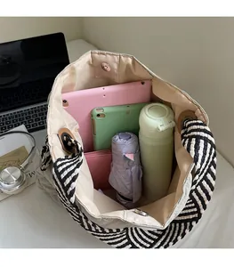 Interior view of quilted beige tote bag showing large capacity and magnetic closure
