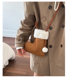Close-up of Christmas sock-shaped shoulder bag with sherpa trim and matte suede texture