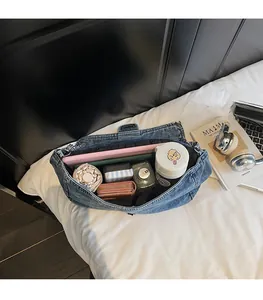Spacious denim shoulder bag interior holding a tablet, umbrella, and daily essentials