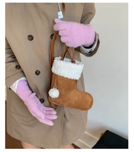 Detail of Christmas stocking crossbody bag in brown suede with white sherpa fleece trim