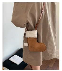 Detail of a Christmas stocking crossbody bag with brown suede and white fuzzy sherpa trim