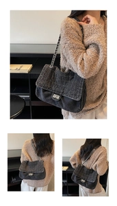 Detailed view of black denim quilted bag featuring silver metal turn-lock and chain strap