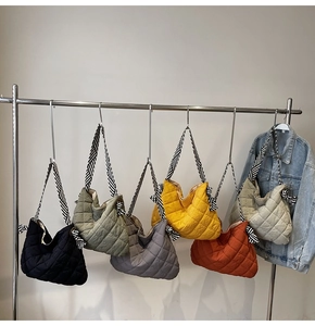 Quilted tote bags in various colors featuring striped woven straps and large capacity