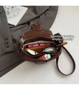 Detailed interior of brown saddle bag showing spacious storage for cosmetics and wallet