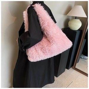 Detailed plush texture of a large pink faux fur tote bag worn with a black coat