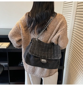 Fashionable denim chain shoulder bag with diamond stitching shown worn by model