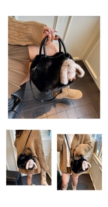 Close-up of black plush crossbody bag with cute rabbit pendant and leather handle detail
