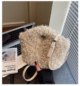 Detail of light beige fuzzy plush handbag texture with adjustable leather strap
