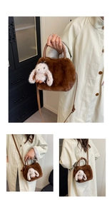 Detail of brown plush crossbody bag with a cute white rabbit charm and faux leather handle