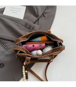 Interior view of brown suede handbag showing spacious storage for phone and wallet
