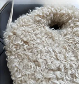 Detailed macro view of cream faux fur texture with soft and curly plush fabric