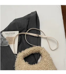 Detail of adjustable faux fur handbag strap on grey suit with artistic props
