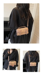 Detailed view of the nude pink Boston cylinder bag showing straps and matte texture