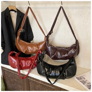 Detail showing the pleated faux leather texture and knotted strap in four retro colors