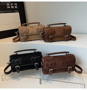 Detail of four retro matte small satchels with decorative bows and vintage buckles