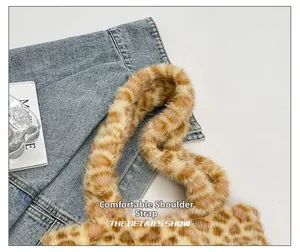 Detail of soft plush leopard print shoulder strap on a fuzzy autumn tote bag