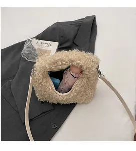 Spacious interior of beige fuzzy plush crossbody bag holding daily essentials
