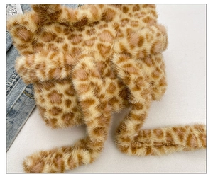 Close-up of leopard print plush tote bag with soft texture and long brown handles