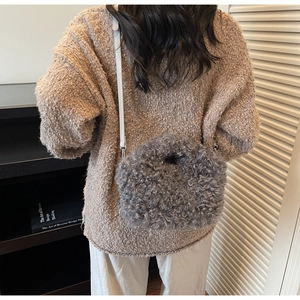 Detail of grey teddy plush crossbody bag with slim strap on knit sweater