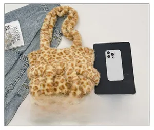 Detailed view of the leopard print plush crossbody bag with soft fuzzy texture and strap