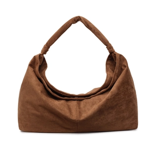 Brown suede hobo bag with large capacity and knotted wide shoulder strap on white background