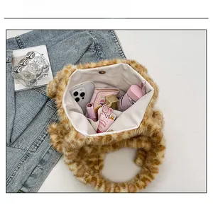 Internal view of leopard print plush tote bag showing large storage capacity and snap button