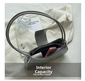 Detail view of the silver grey shoulder bag interior showing spacious capacity for phone