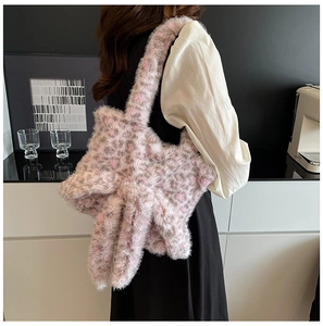 Pink leopard print faux fur tote bag shown on model in a modern interior setting