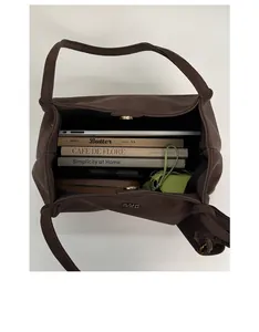 Top view of spacious coffee brown leather tote showing ample interior for a tablet and books