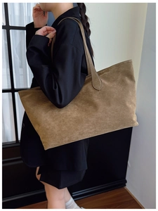 Brown faux suede tote bag shown on model highlighting the large capacity and matte texture
