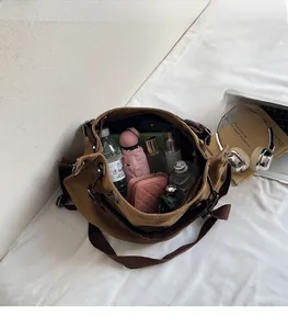 Spacious interior of brown canvas tote showing room for water bottle and daily essentials