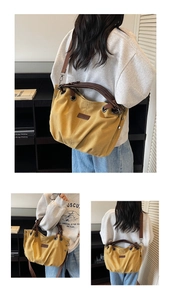 Detail view of mustard yellow canvas tote bag with brown leather straps and metal eyelets