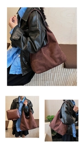 Detail of a large brown suede tote bag set with matching inner pouch on a wooden shelf