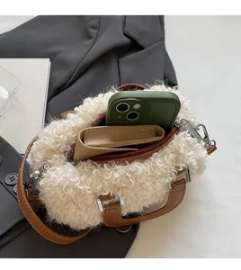 Top view of plush cream faux fur bag interior showing spacious storage for a phone and wallet