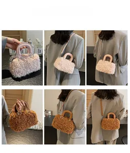 Detail of plush fuzzy Boston bag in beige and brown with leather handles and strap