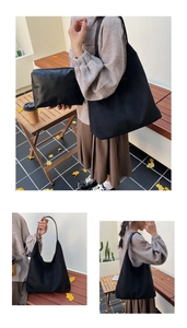 Detail of black suede tote bag and matching zipper pouch for daily commuting use