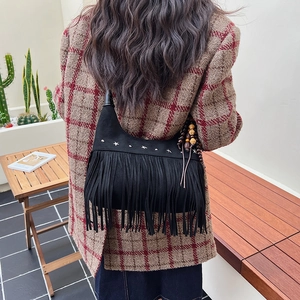 Bohemian black suede tassel crossbody bag with star rivets and fringe details