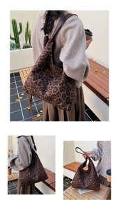 Detail of a large leopard print suede tote bag with durable dark brown leather handles