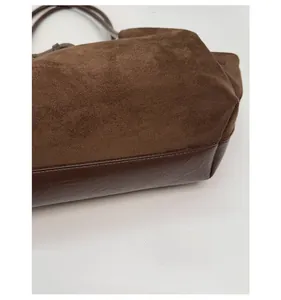 Close-up of dark brown tote bag base with premium matte suede and reinforced leather
