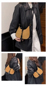 Detail of vintage crescent bag showing brown suede and black leather stitching design