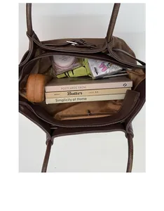Top view of spacious brown tote bag interior showing compartments for daily essentials