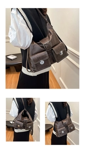 Detail view of large retro brown tote bag with multi-pockets and metal buckles