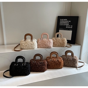 Detailed display of fuzzy box bags in seven colors with leather handles and straps