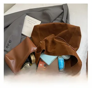 Macro view of spacious dark brown tote interior with matching clutch and daily essentials
