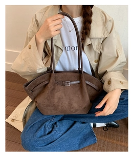Detailed texture of dark brown matte suede tote bag styled with a minimalist trench coat