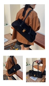 Detailed view of black matte bowling bag with vintage gold buckle and long shoulder strap