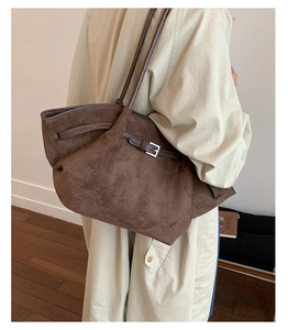 Detail of vintage large brown matte tote bag with silver metal buckles and straps