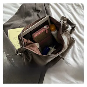 Macro view of spacious brown faux leather tote interior showing daily essentials storage