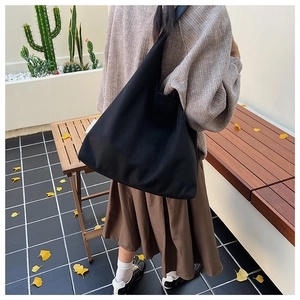 Minimalist black large capacity suede tote bag showing soft texture and wide shoulder strap